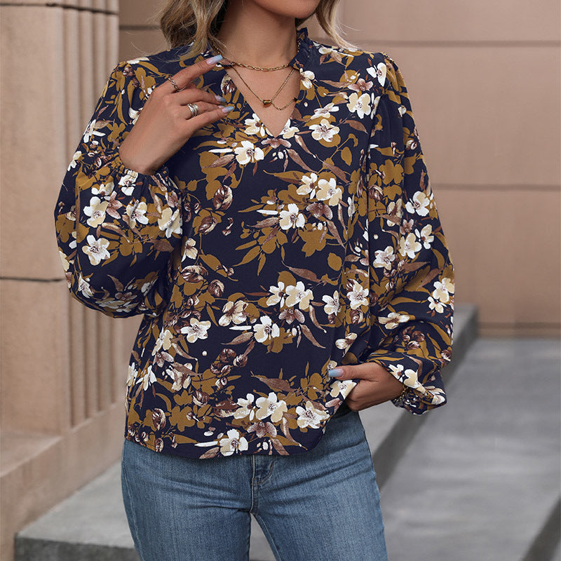 Women's lightweight chiffon blouse with floral all-over print, V-neck and voluminous gathered sleeves Mune Fashion