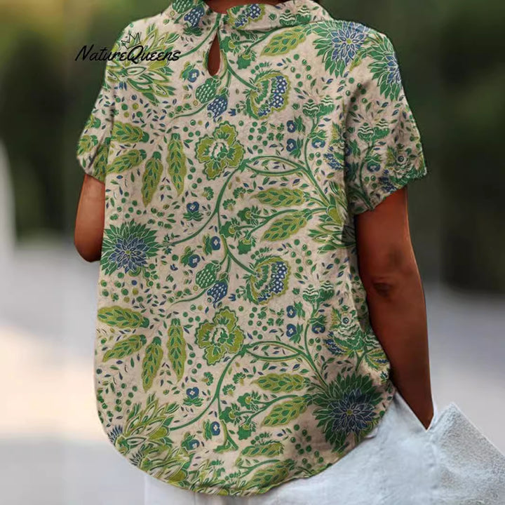 Women's casual short-sleeve blouse with V-neck, rounded hem, and botanical all-over print Mune Fashion