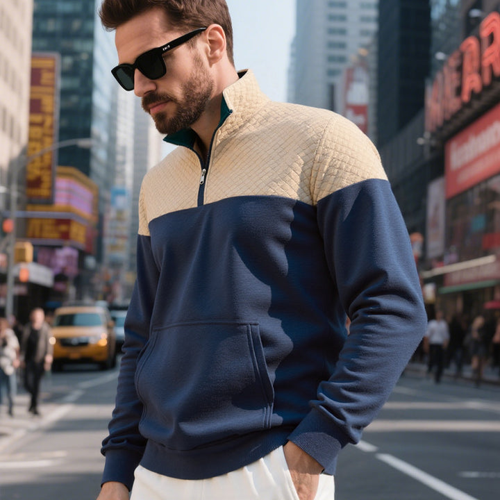 Men's color block half zip sweatshirt with quilted chest area, kangaroo pocket, and elastic cuffs Mune Fashion