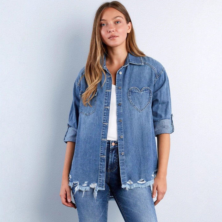 Women's casual denim shirt jacket oversized with patch chest pockets, heart embroidery detail, and frayed hem Mune Fashion