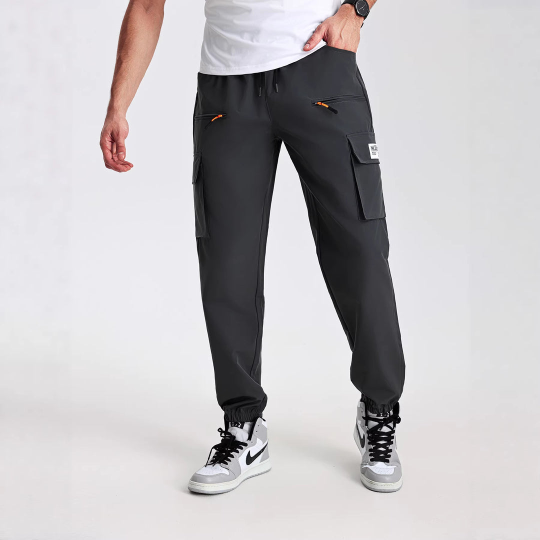 Men's tapered cut utility cargo pants in jogger style with drawstring waistband, zippered pockets & elastic leg cuffs Mune Fashion