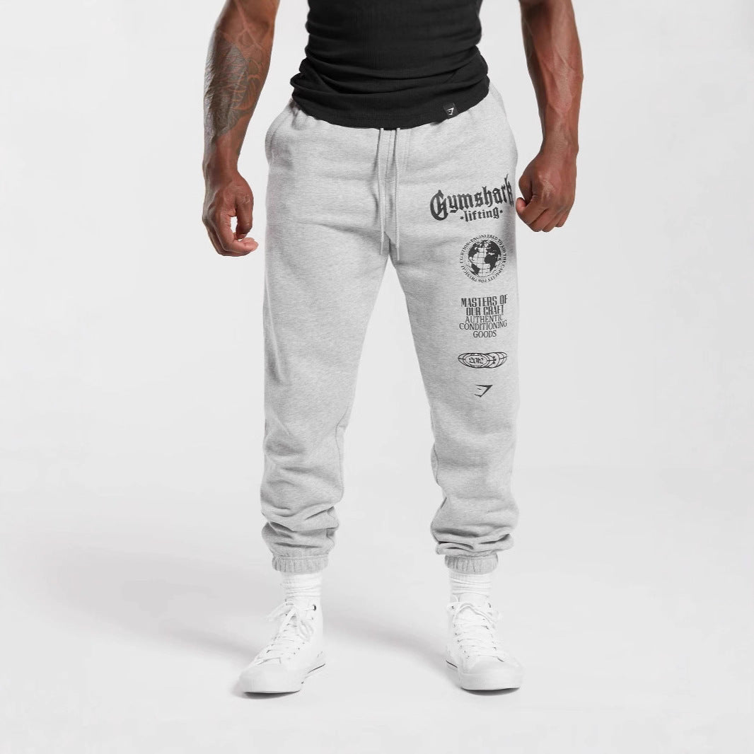 Men's tapered cotton fleece sweatpants with an elastic drawstring waistband, ribbed leg openings, and large logo print Mune Fashion