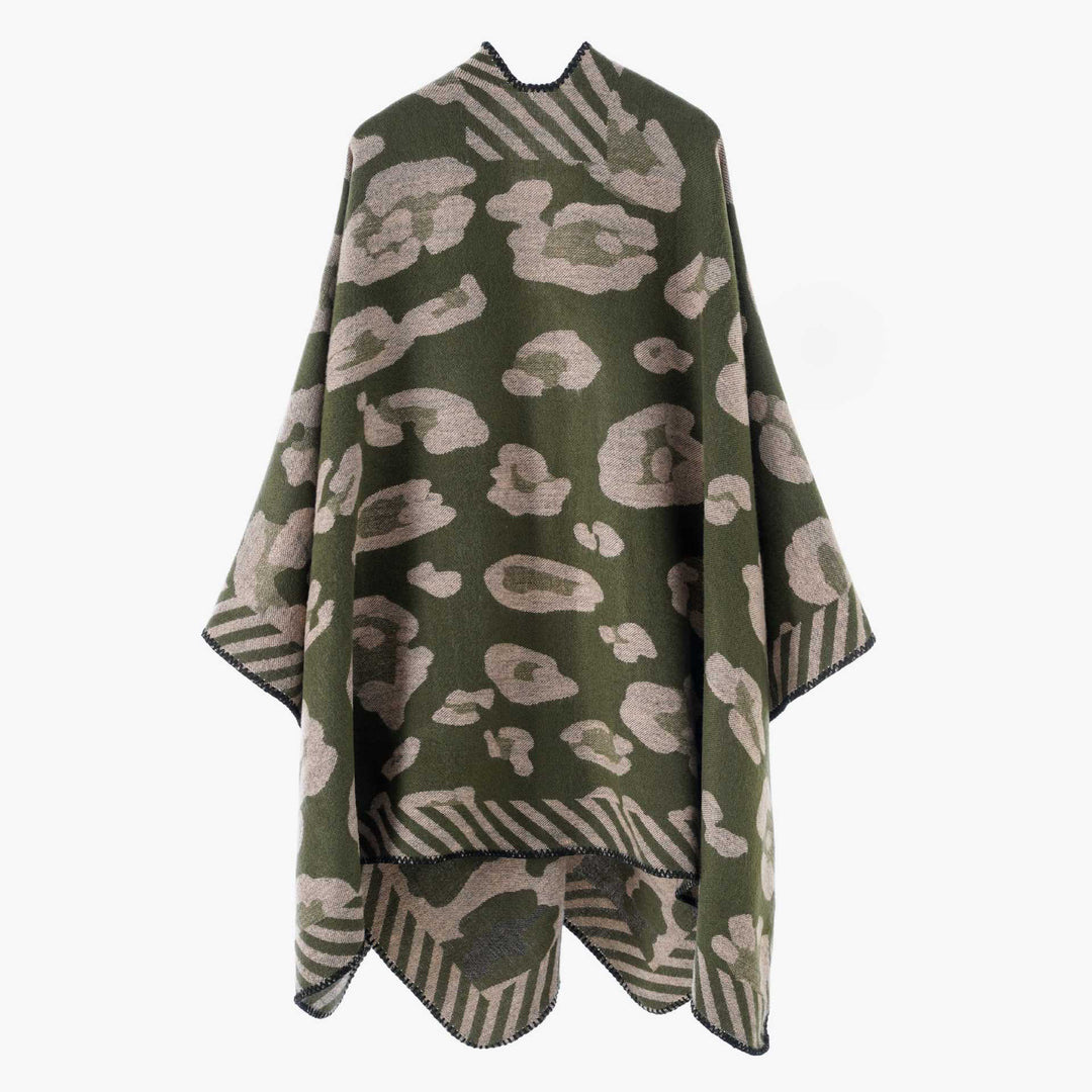Women's chunky knit wool cape in a wrap style with abstract leopard pattern and decorative edge Mune Fashion