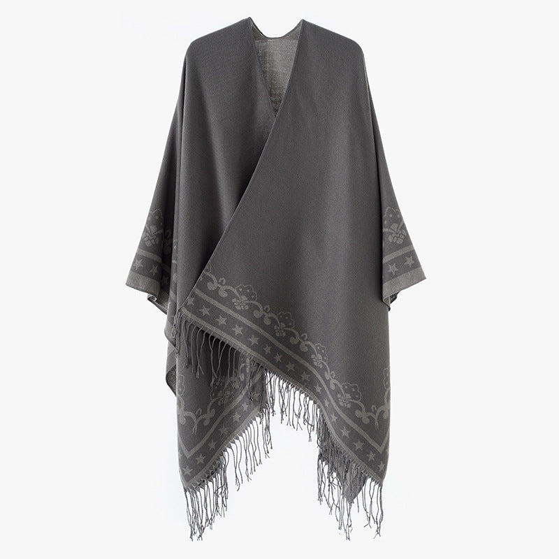 Women's poncho wrap made of wool blend with subtle jacquard border pattern and fringed hem Mune Fashion