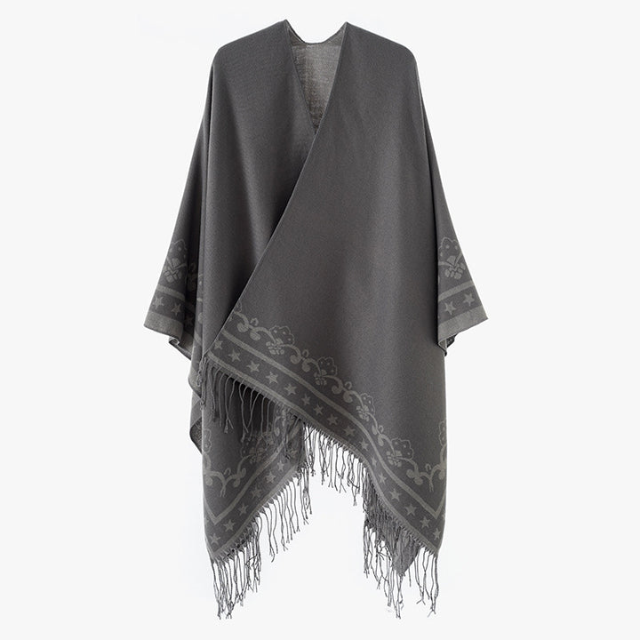 Women's poncho wrap made of wool blend with subtle jacquard border pattern and fringed hem Mune Fashion