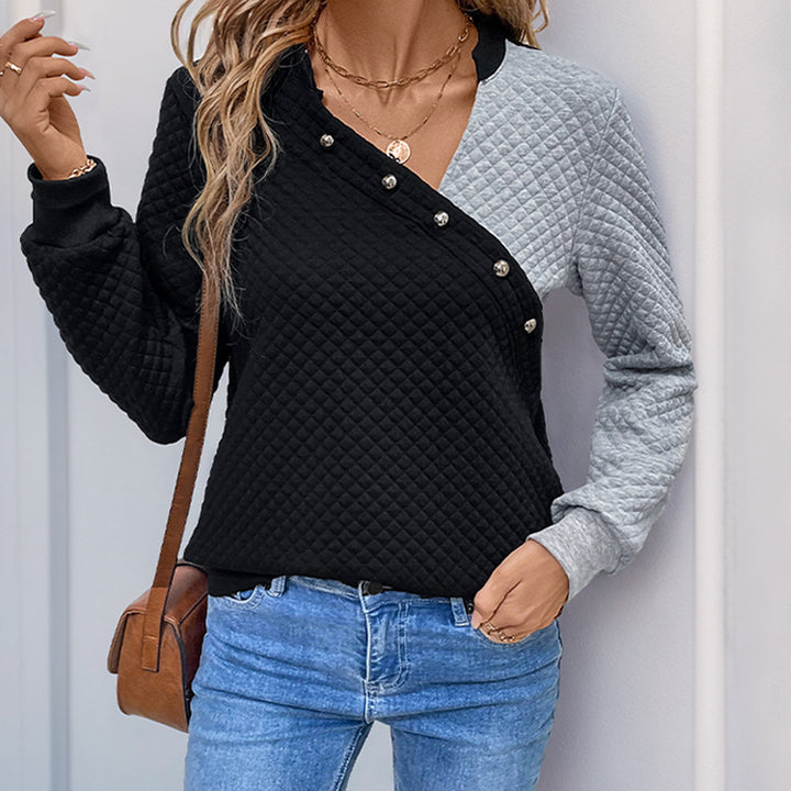 Women’s quilted sweatshirt with asymmetric lapel, decorative press buttons, and color block sleeves Mune Fashion