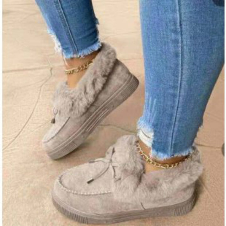 Women's Cozy Moccasin Slippers with high-pile fur cuff, decorative stitching, and lightweight platform sole profile Mune Fashion