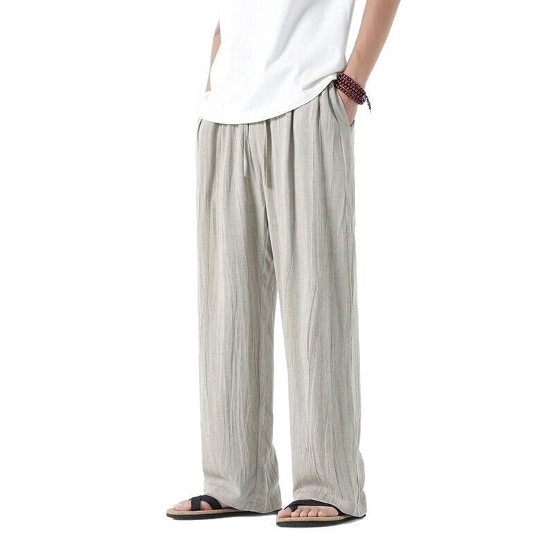 Men's loose linen trousers with adjustable drawstring waistband, casual pleat look, and side pockets Mune Fashion