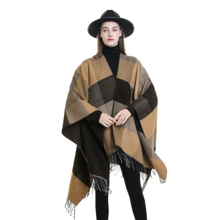 Women’s web cape in a boxy ruana cut with diagonal check pattern and fringes