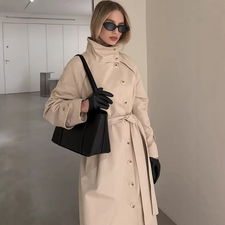 Ladies maxilength trench coat with high stand-up collar, double-breasted button placket and tie belt Mune Fashion