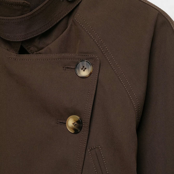 Women's short trench coat with high stand-up collar, tie belt, and asymmetrical button placket Mune Fashion