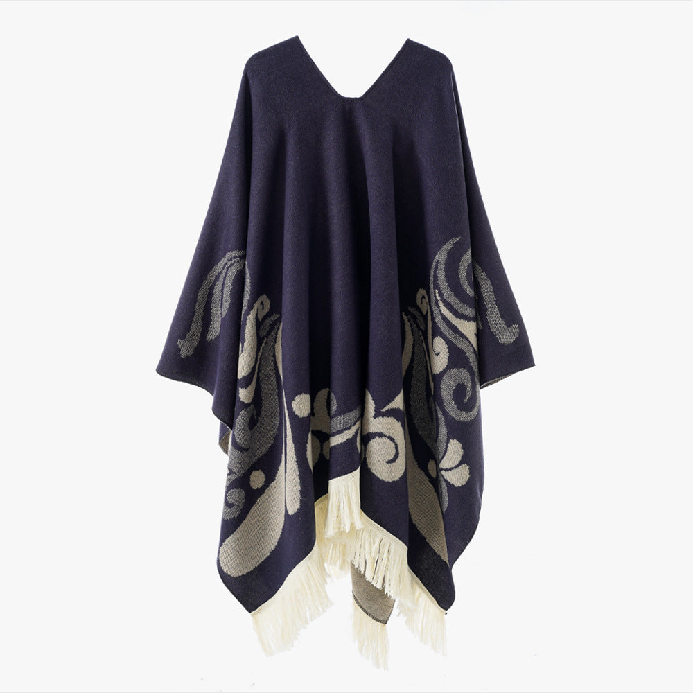 Women's wool blend poncho in cape style with V-neck, contrasting ornament jacquard and fringes.