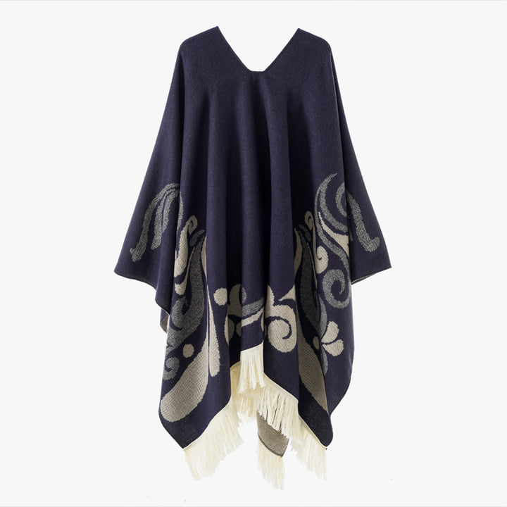 Women's wool blend poncho in cape style with V-neck, contrasting ornament jacquard and fringes.
