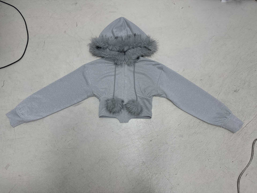Women's cropped hoodie sweatshirt with faux fur trim, zipper, and pom-pom cords Mune Fashion