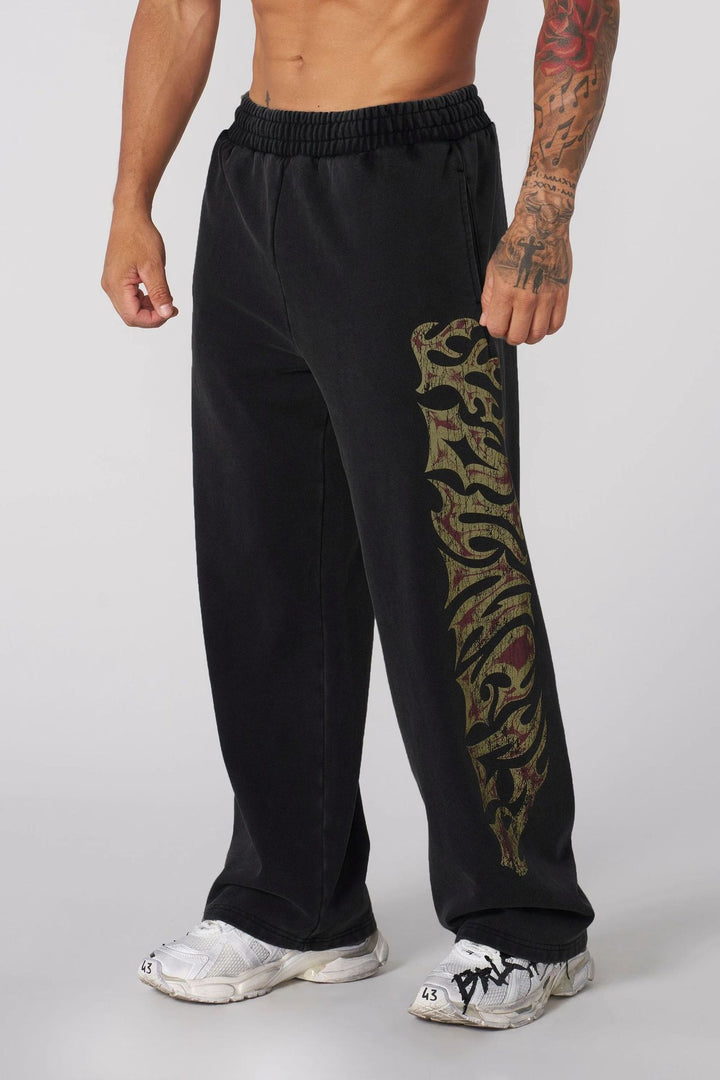 Men's baggy joggers with elastic waistband, side pockets and detailed skull and rose motif Mune Fashion