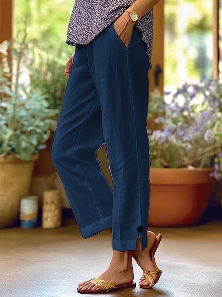 Women's linen trousers with a relaxed, ankle-length fit, side pockets and decorative button details Mune Fashion