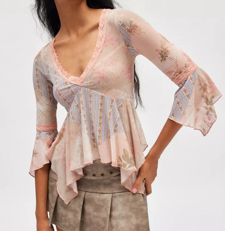 Ladies sheer mesh top with V-neck, lace trim, asymmetric ruffle hem, and bell sleeves Mune Fashion
