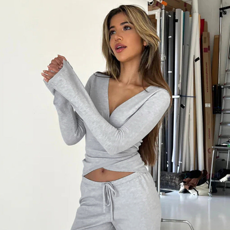 Women's wrap cropped top with deep V-neck, fitted wrap shape, and long bell sleeves Mune Fashion