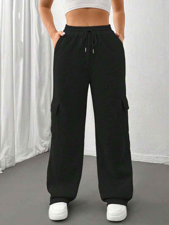 Ladies cargo jogging pants with high elastic waistband, drawstring, and wide leg Mune Fashion