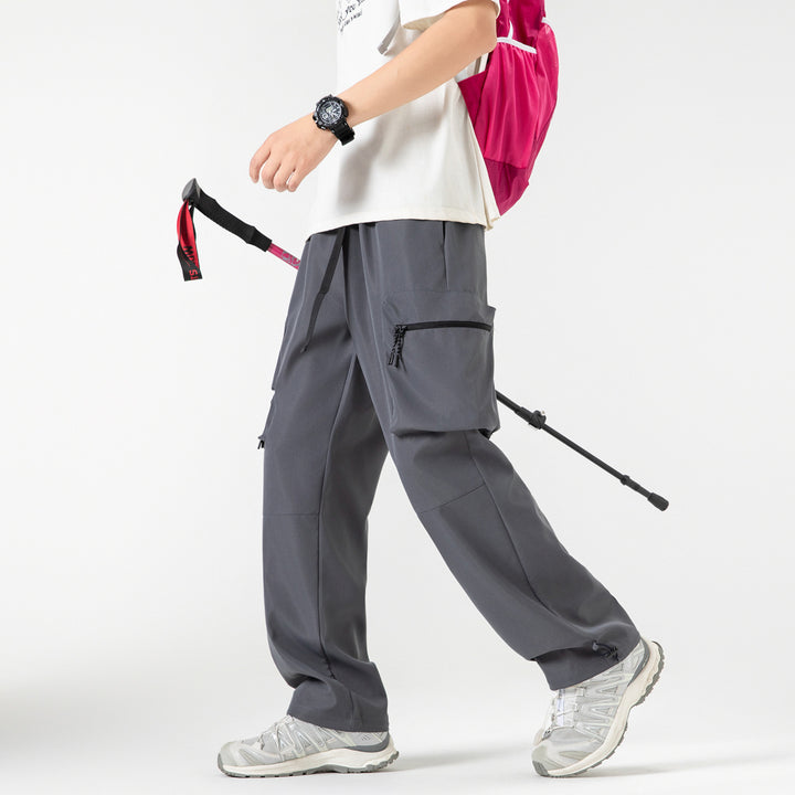 Men's loose technical cargo pants with multi-functional pockets, drawstring waistband, and adjustable leg closures Drune