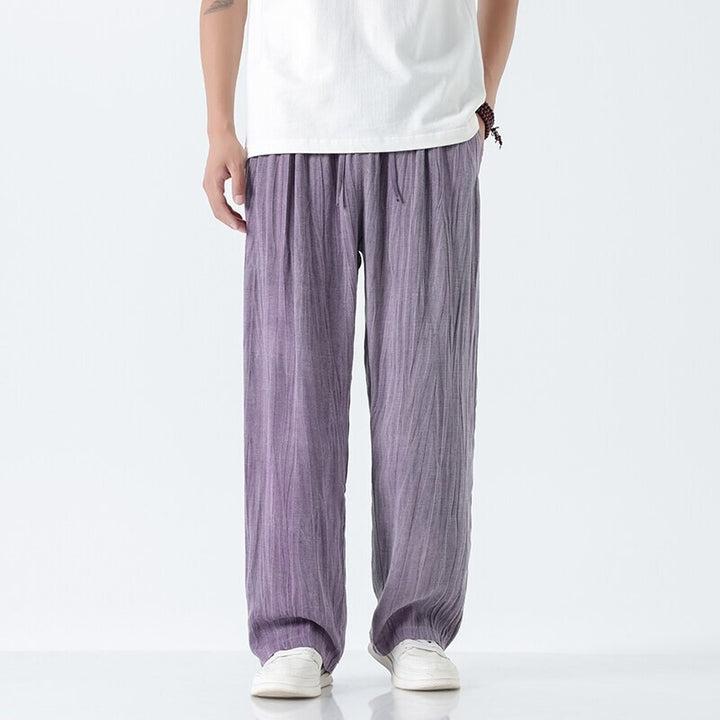 Men's loose linen trousers with adjustable drawstring waistband, casual pleat look, and side pockets Mune Fashion