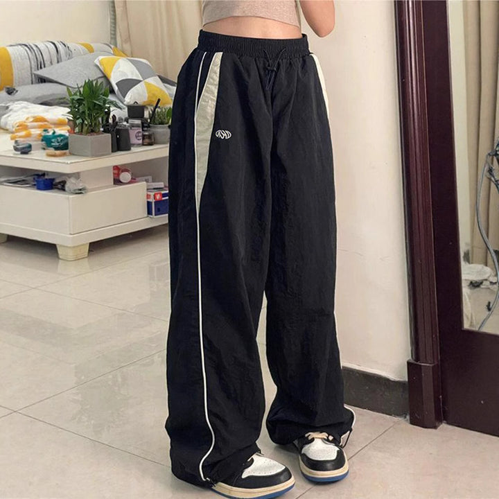 Women's wide track pants with contrast piping, elastic waistband and oversized fit Mune Fashion