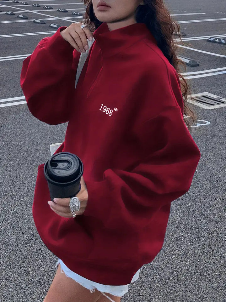 Women's oversized half-zip sweatshirt with high collar, kangaroo pocket, and casual oversized fit Mune Fashion