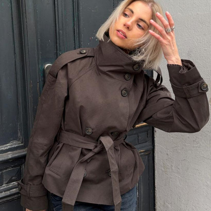 Women's short tailored trench coat with high standing collar, double-breasted button placket, and adjustable tie belt Mune Fashion