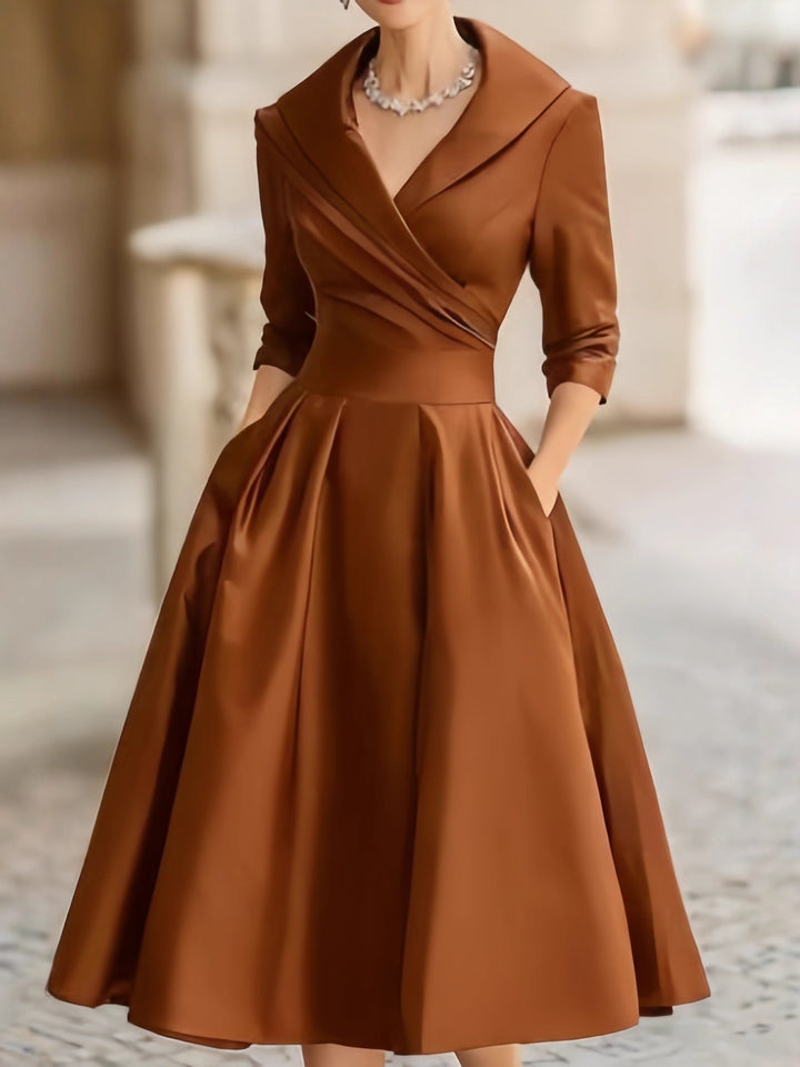 Women's elegant midi dress with wrap top, three-quarter sleeves, and side pockets Mune Fashion
