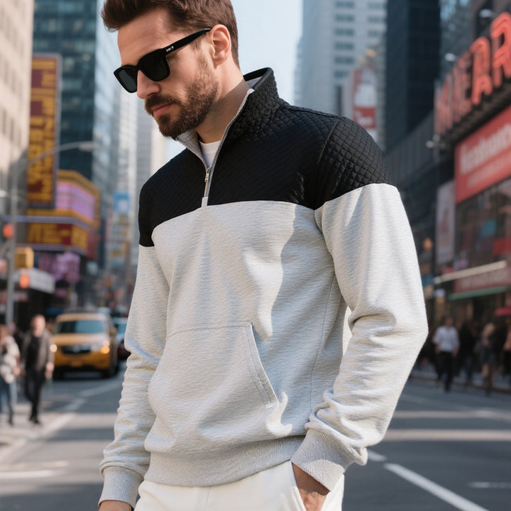 Men's color block half zip sweatshirt with quilted chest area, kangaroo pocket, and elastic cuffs Mune Fashion