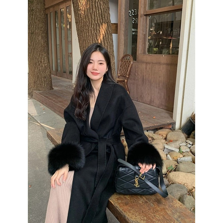Women's Long Wool Blend Coat with Waist Belt and Voluminous Fur Trim at Sleeve Ends Mune Fashion