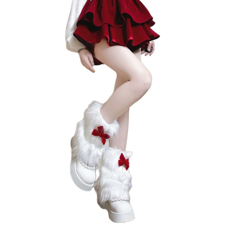 Ladies cozy boot cuffs made of faux fur with bow appliqué and pompons Mune Fashion