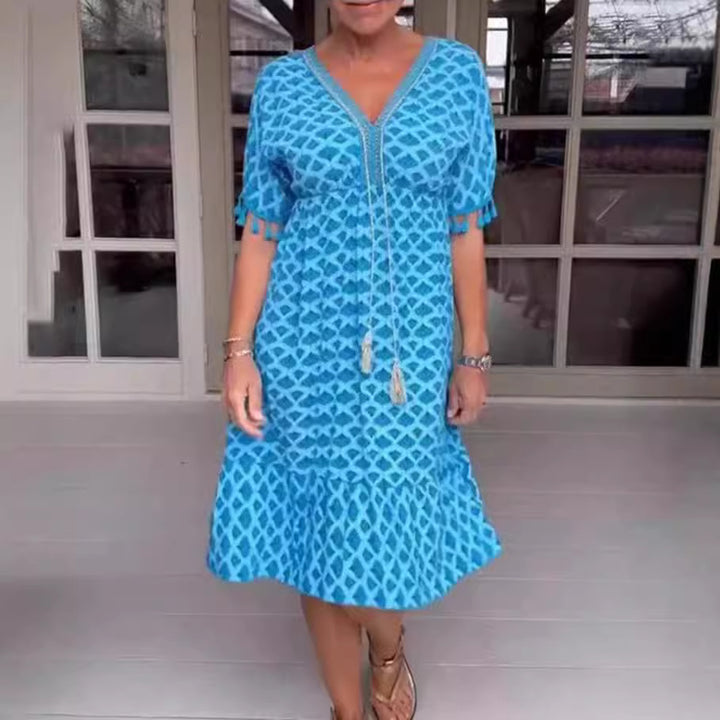 Women's casual midi dress in kaftan style with V-neck, tassel band, gathered empire seam, and fringe sleeves Mune Fashion