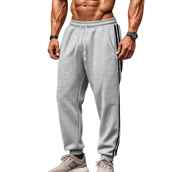 Men's sporty jogging pants with side contrast stripes, elastic drawstring waistband, and ribbed leg endings Mune Fashion