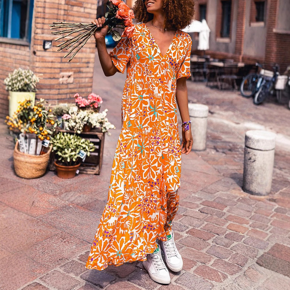 Women’s ankle-length V-neck maxi dress with graphic ethnic print, short sleeves and flared ruffle hem Mune Fashion