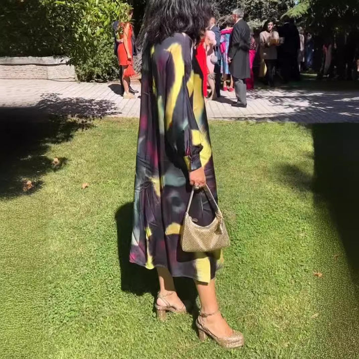 Women's flowing midi dress with abstract print, V-neckline, balloon sleeves, and decorative closure Mune Fashion