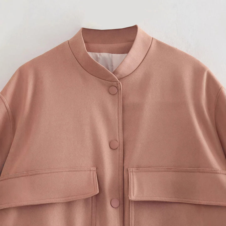 Women's short bomber jacket with stand-up collar, snap button placket, patch pockets, and elastic hem Mune Fashion
