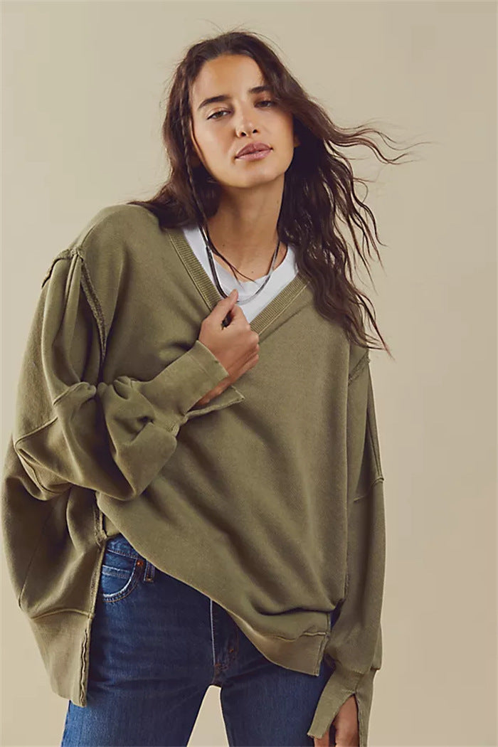 Women's oversized sweatshirt with balloon sleeves, open seam stitches, and side slits Mune Fashion