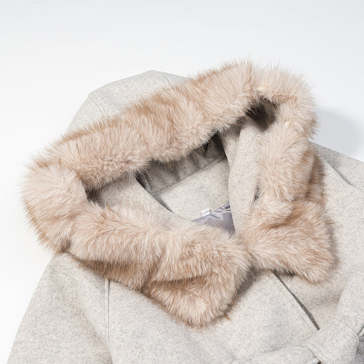 Women's hooded coat in cape cut with faux fur collar, tie belt, and patch pockets Mune Fashion