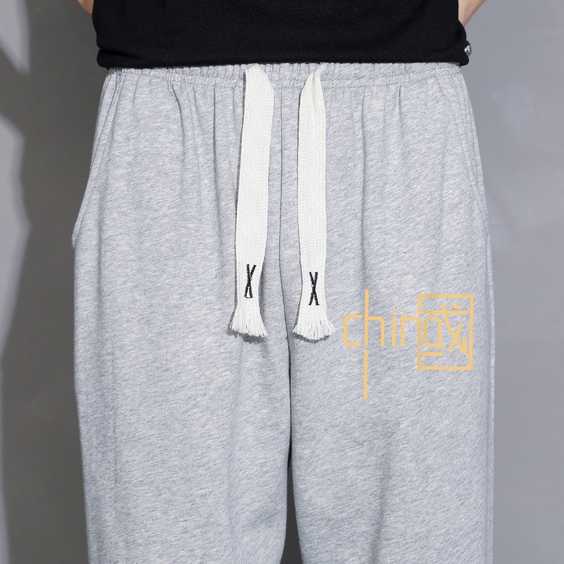 Men's loose fitting sweatpants with drawstring, elastic cuffs, and side pockets Mune Fashion