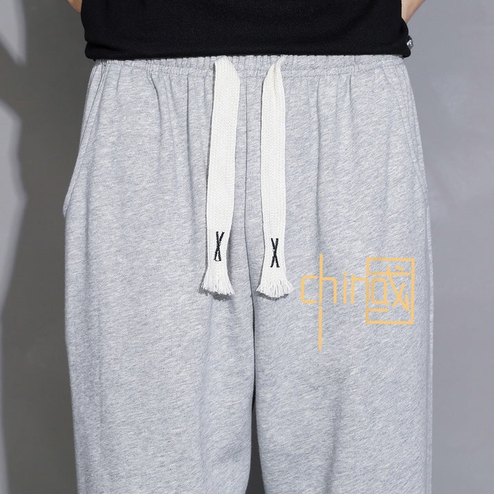 Men's loose fitting sweatpants with drawstring, elastic cuffs, and side pockets Mune Fashion