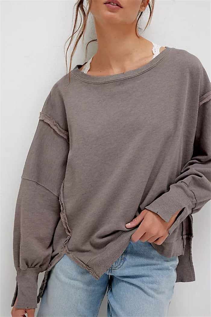 Women's oversized sweatshirt with balloon sleeves, open seam stitches, and side slits Mune Fashion