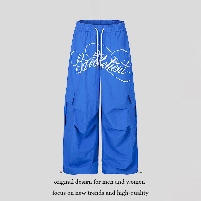 Women's wide palazzo cargo pants with elastic drawstring waistband, large flap pockets, and statement writing print Mune Fashion