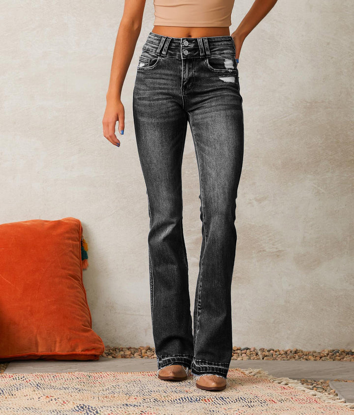 Ladies high-waisted vintage bootcut jeans with double button fly, light destroyed detail, and frayed hem Mune Fashion