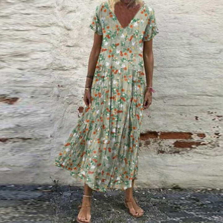 Women’s V-neck maxi dress with fine pleated skirt, empire bodice and short sleeves Mune Fashion