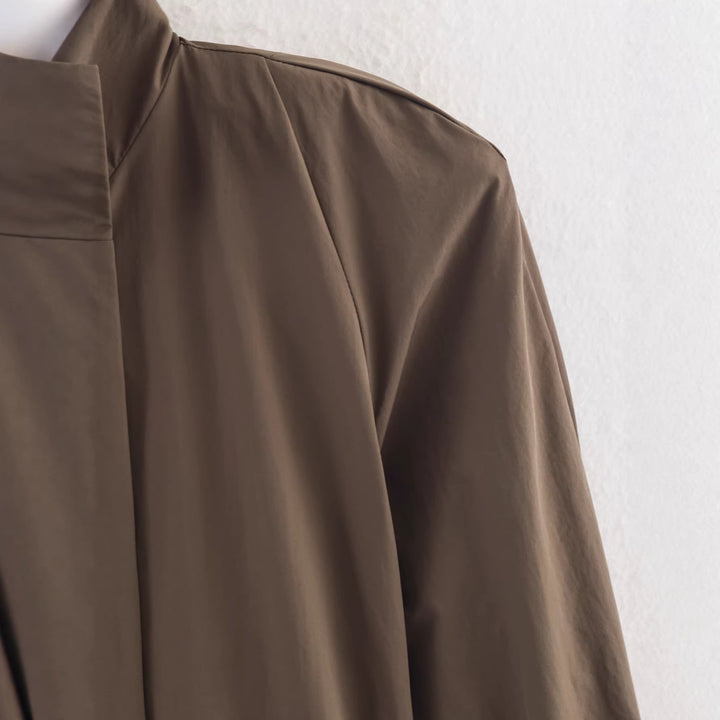 Women's short trench coat with high standing collar, double snap button placket and waist belt Mune Fashion