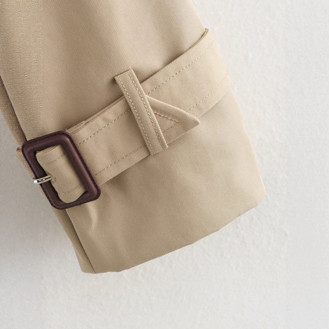Women's cropped trench coat with double-breasted button placket, applied storm flap, and adjustable cuffs Mune Fashion