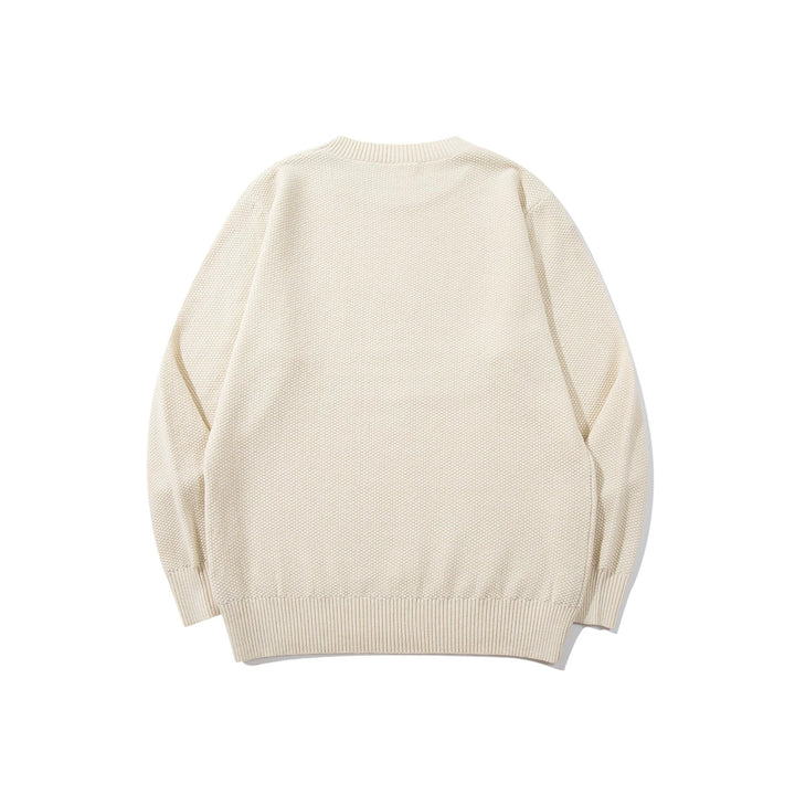 Unisex chunky knit round neck sweater with textured purl stitch and ribbed cuffs