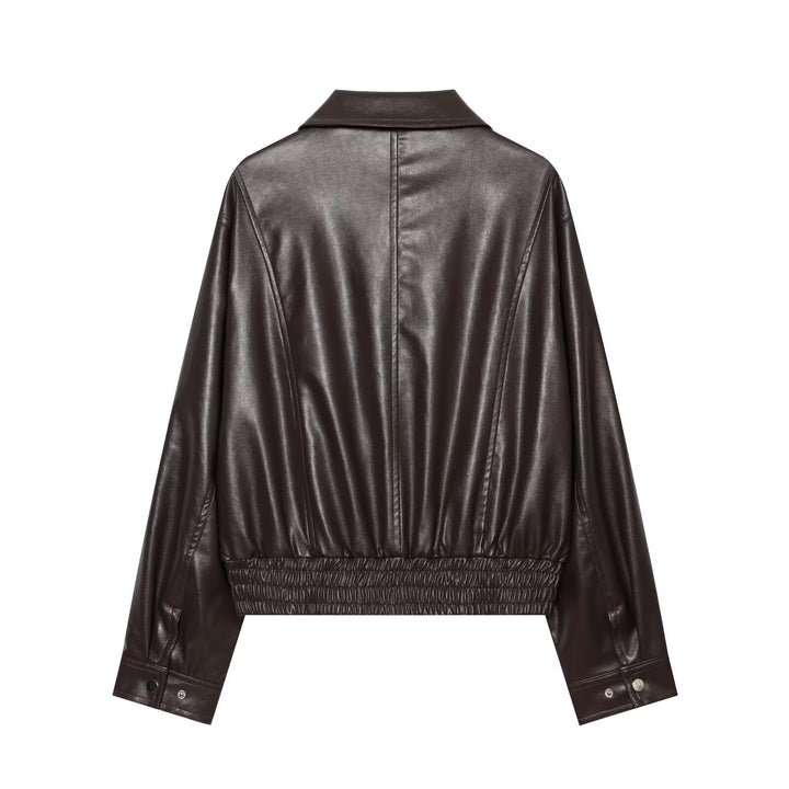 Women's short jacket in leather look with oversized shirt collar, flap pockets, and gathered hem.