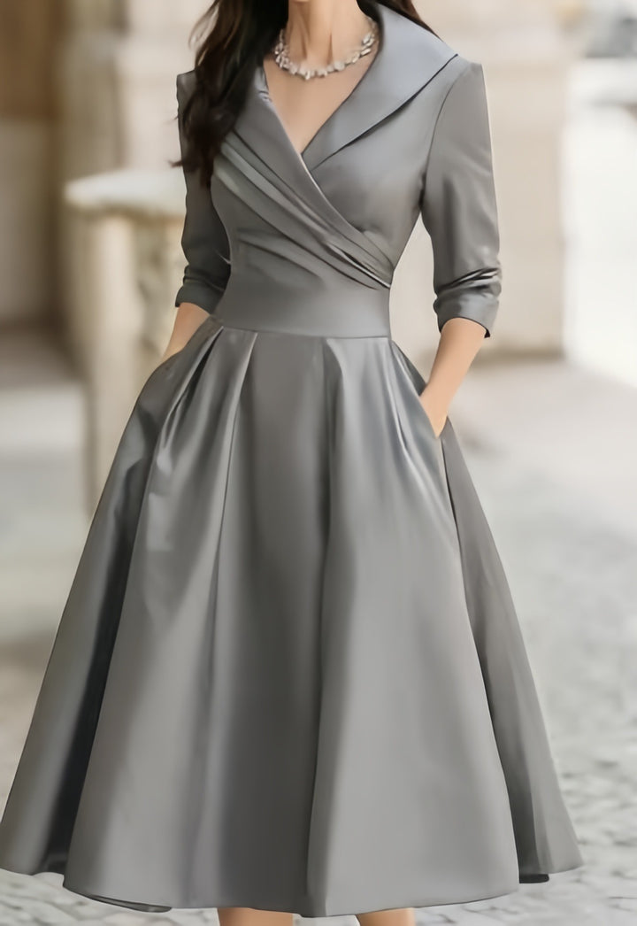 Women's elegant midi dress with wrap top, three-quarter sleeves, and side pockets Mune Fashion